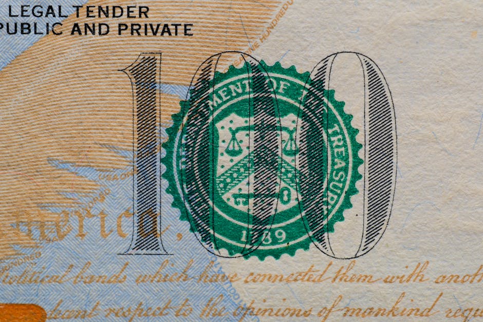 Stablecoins Could Hit $719 Trillion — and Washington Is Watching 1 Detailed view of the US 100 dollar bill showing the Treasury seal and printed text.