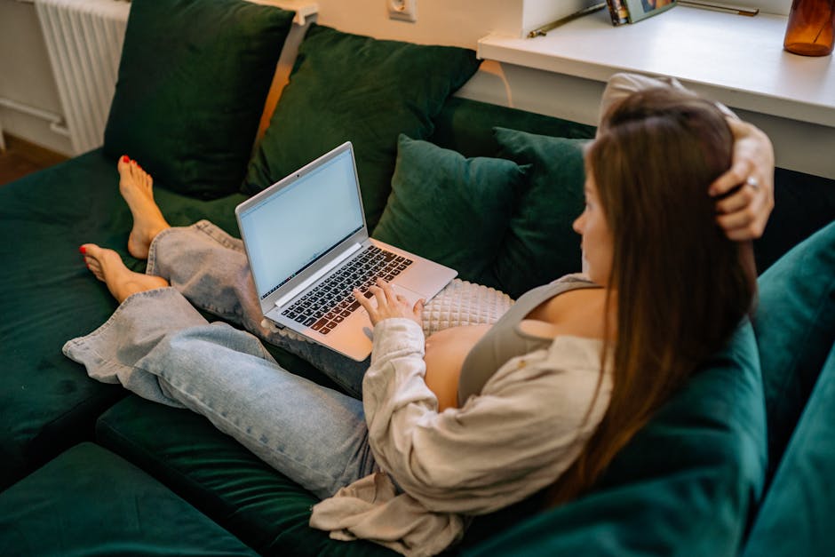 $22.5m ruling puts pregnancy accommodation in the dock 1 A pregnant woman working remotely from home, using a laptop on a sofa.